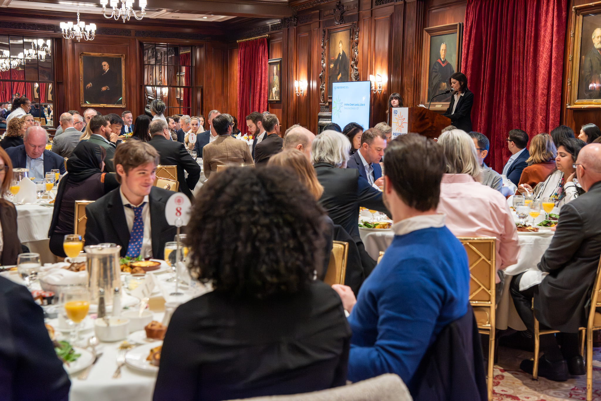 ICP Breakfast 2025 View of room, AGL at lectern (2).jpg